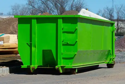 Roll-off dumpster loaded with debris at a construction site